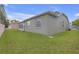 Exterior shot of the house showing the enclosed sunroom and the well-maintained backyard at 7246 Julian St, New Port Richey, FL 34653
