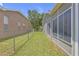 Spacious backyard with a fenced boundary, a well-maintained lawn and an enclosed sunroom at 7246 Julian St, New Port Richey, FL 34653