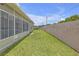 Large backyard with an enclosed sunroom, perfect for outdoor activities and relaxation at 7246 Julian St, New Port Richey, FL 34653