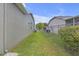View of the side yard featuring a fenced boundary, grass and access to backyard at 7246 Julian St, New Port Richey, FL 34653