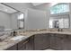Elegant bathroom featuring dual sinks, granite countertops, and modern fixtures, offering luxury at 7246 Julian St, New Port Richey, FL 34653