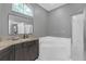 Main bathroom features a corner soaking tub, separate shower, granite vanity, and natural light at 7246 Julian St, New Port Richey, FL 34653