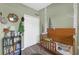 Bedroom features hardwood floors, a white closet, and birch-themed wallpaper, creating a calming ambiance at 7246 Julian St, New Port Richey, FL 34653