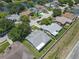 Aerial view of a residential neighborhood with mature trees and a community lake at 7246 Julian St, New Port Richey, FL 34653
