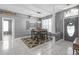 Dining room featuring white tile flooring, a modern chandelier, and a front door view at 7246 Julian St, New Port Richey, FL 34653