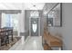 Welcoming entryway with an oval-window door, a pendant light, and a console table, all accented by a large mirror at 7246 Julian St, New Port Richey, FL 34653