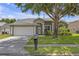 Inviting single-story home with a well-maintained lawn and lovely landscaping, offering great curb appeal at 7246 Julian St, New Port Richey, FL 34653