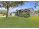 Well-kept home with lush green lawn, mature landscaping, and a convenient two-car garage at 7246 Julian St, New Port Richey, FL 34653