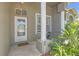 Charming front porch featuring an arched doorway, decorative columns and a sweet welcome mat at 7246 Julian St, New Port Richey, FL 34653