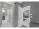 Bright hallway leads to the main bathroom and living room, with sleek tile flooring and neutral paint at 7246 Julian St, New Port Richey, FL 34653