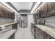 Well-equipped kitchen boasting granite countertops, stainless steel appliances, and pristine tile flooring at 7246 Julian St, New Port Richey, FL 34653