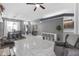 Open-concept living area with white tile flooring, comfortable seating, and a dining space at 7246 Julian St, New Port Richey, FL 34653
