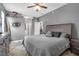Comfortable main bedroom features a ceiling fan, gray walls, neutral furnishings, and a view to the bathroom at 7246 Julian St, New Port Richey, FL 34653