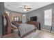 Spacious main bedroom features a ceiling fan, gray walls, a decorative accent wall, and comfortable furnishings at 7246 Julian St, New Port Richey, FL 34653