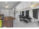 The covered patio includes a geometric patterned floor, ceiling fans, lounge seating, and outdoor string lights at 7246 Julian St, New Port Richey, FL 34653