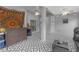 The covered patio features a geometric patterned floor, ceiling fans, and a bar area, perfect for entertainment at 7246 Julian St, New Port Richey, FL 34653