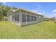 Enclosed sunroom with multiple windows providing ample natural light and views of the backyard at 7246 Julian St, New Port Richey, FL 34653