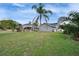 A beautifully landscaped backyard with a screened pool and tropical plants enhances outdoor living at 728 Camrose Dr, Brandon, FL 33510
