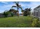 This backyard features a spacious lawn with mature trees offering a park-like setting at 728 Camrose Dr, Brandon, FL 33510