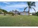 An expansive backyard with a screened pool area and mature palms offering privacy at 728 Camrose Dr, Brandon, FL 33510