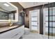 This primary bathroom has tile walls, modern vanity and glass-enclosed shower at 728 Camrose Dr, Brandon, FL 33510