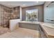 Bathroom featuring a soaking tub, tile floors and a walk-in shower at 728 Camrose Dr, Brandon, FL 33510