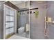 This modern bathroom boasts a tiled shower with an overhead and handheld showerhead at 728 Camrose Dr, Brandon, FL 33510