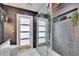 Modern bathroom features a glass enclosed shower with matte walls and shelving at 728 Camrose Dr, Brandon, FL 33510