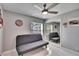 Bedroom features tile floors, ceiling fan, a large window, and a mirrored closet at 728 Camrose Dr, Brandon, FL 33510