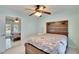 The bedroom offers a decorative headboard, mirrored closet and ceiling fan at 728 Camrose Dr. Dr, Brandon, FL 33510