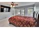 Bright bedroom with tile floors, ceiling fan and access to the lanai and pool at 728 Camrose Dr, Brandon, FL 33510