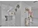 Bright entry way with modern white tile flooring, decorative wall art, and open view to the kitchen at 728 Camrose Dr, Brandon, FL 33510
