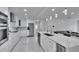 Modern kitchen with white cabinets, stainless steel appliances, and a large waterfall island at 728 Camrose Dr, Brandon, FL 33510