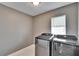 Well-lit laundry room with side-by-side Samsung washer and dryer on marble floors at 728 Camrose Dr, Brandon, FL 33510