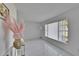 Bright living room with modern white tile flooring, large window, and simple decor at 728 Camrose Dr, Brandon, FL 33510