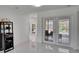 Spacious living room with white tile flooring and French doors leading to the pool area at 728 Camrose Dr, Brandon, FL 33510