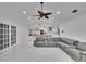 Open living area with marble floors, vaulted ceiling, gray sectional sofa, and view to the kitchen at 728 Camrose Dr, Brandon, FL 33510