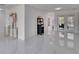 Spacious entry with white tile flooring flowing into the living area and backyard views at 728 Camrose Dr, Brandon, FL 33510