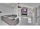 Bright living room with marble floors, modern fireplace and tv above, and comfortable gray sectional sofa at 728 Camrose Dr, Brandon, FL 33510