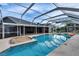 Enclosed pool with a shallow tanning deck, gravel area, lounge chair and an inflatable toy at 728 Camrose Dr, Brandon, FL 33510