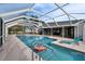 Enclosed pool with a lounge chair and an inflatable toy, surrounded by a spacious patio area at 728 Camrose Dr, Brandon, FL 33510