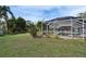 The screened-in pool area is surrounded by lush greenery, perfect for relaxation and privacy at 728 Camrose Dr, Brandon, FL 33510