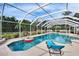 Enclosed pool with a lounge chair and an inflatable toy, surrounded by lush vegetation at 728 Camrose Dr, Brandon, FL 33510