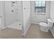 Contemporary bathroom featuring a standing shower, toilet, and ceramic tile floor at 8452 Silverbell Loop, Brooksville, FL 34613