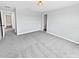 Bright bedroom featuring neutral walls, carpeted floors, and a closet for practical living at 8452 Silverbell Loop, Brooksville, FL 34613