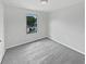 Comfortable bedroom with neutral carpet and a window providing natural light at 8452 Silverbell Loop, Brooksville, FL 34613