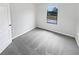 Cozy bedroom with a neutral carpet and a view of the backyard at 8452 Silverbell Loop, Brooksville, FL 34613
