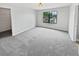 Spacious bedroom featuring a large window and neutral carpet and paint at 8452 Silverbell Loop, Brooksville, FL 34613