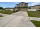 Two-story home with a paved driveway, well-maintained yard, and a neutral exterior paint scheme at 8452 Silverbell Loop, Brooksville, FL 34613