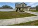 Two-story home boasting well-maintained lawn, fresh landscaping, and a private backyard with white fence at 8452 Silverbell Loop, Brooksville, FL 34613